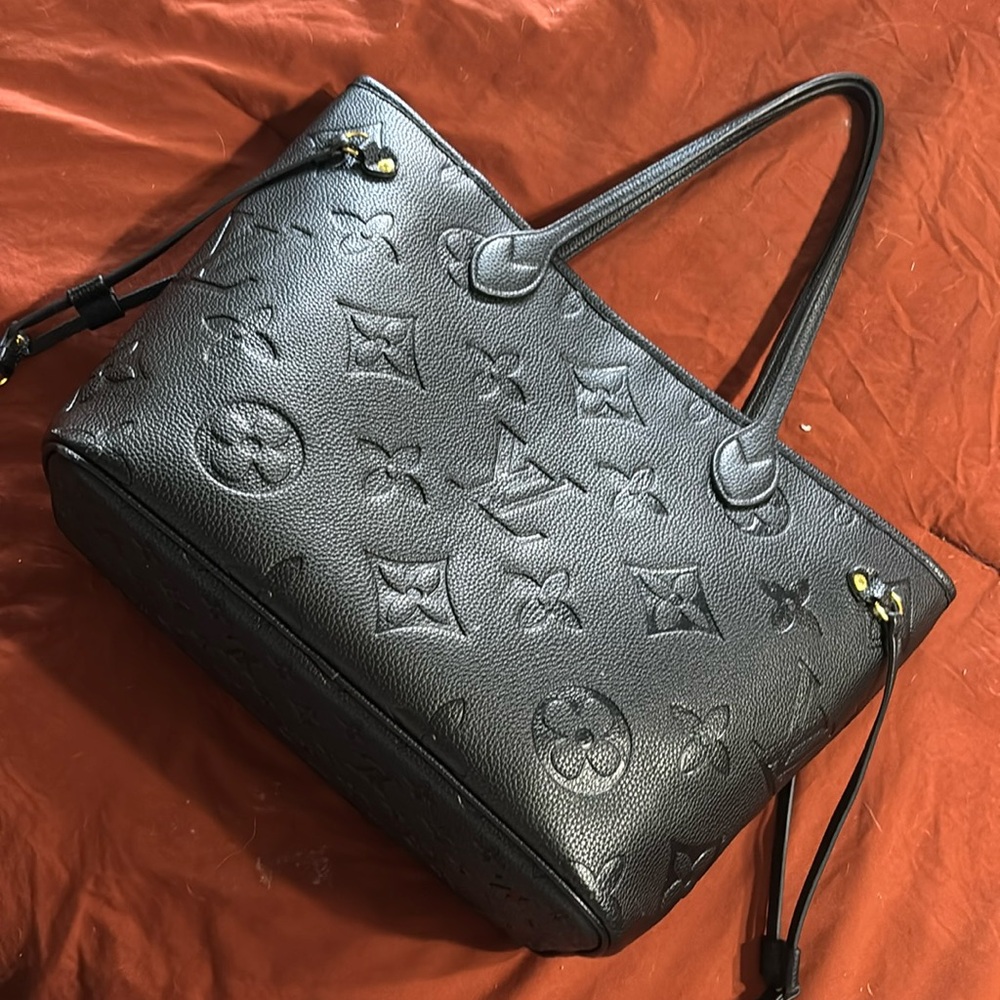 Louis Vuitton Giant Monogram Empreinte Neverfull MM Tote.
